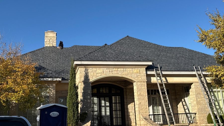 Finished architectural shingle roof on a large stone estate home