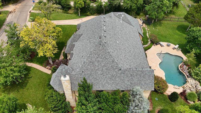 Aerial view of a finished GAF architectural shingle roof with pool in Oklahoma City
