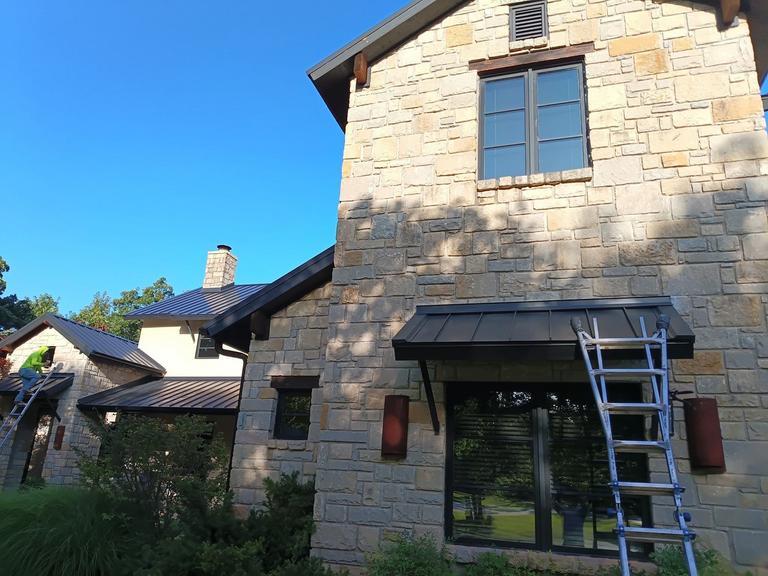 Dark bronze standing seam metal roof on a stone home in Oklahoma City