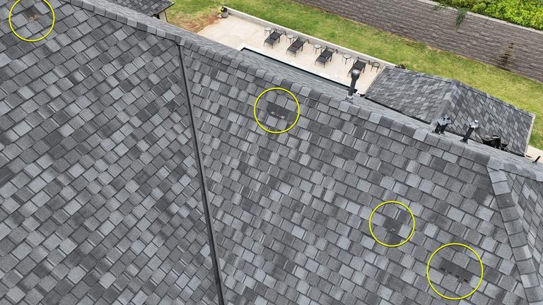 Aerial photo of hail damage markers circled on a roof in Norman, Oklahoma