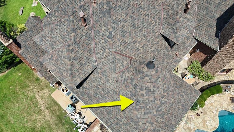 Roof with a dramatic conical turret and pool in Edmond, Oklahoma